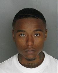 Photo shows Tyrone Creighton who is an African-American male wearing a white t-shirt. He has some hair on his chin.