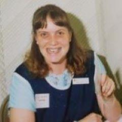 Mary Lee Gericke has brown shoulder length hair and is smiling.